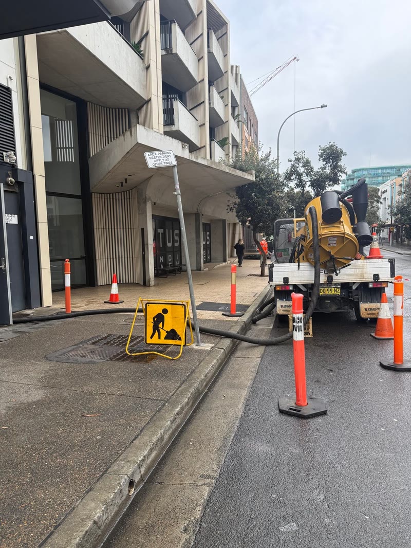 Vacuum equipment working beside an urban construction site