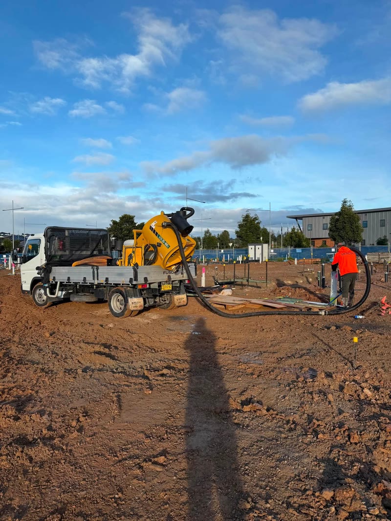 Vacuum equipment working across a large open construction site