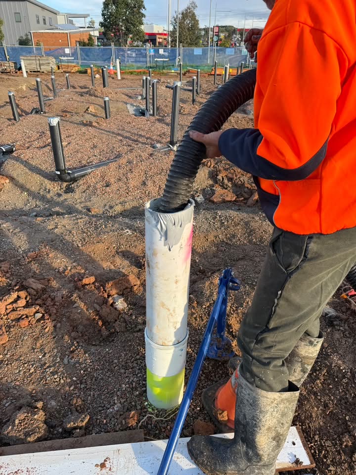 Suction hose positioned within an excavation