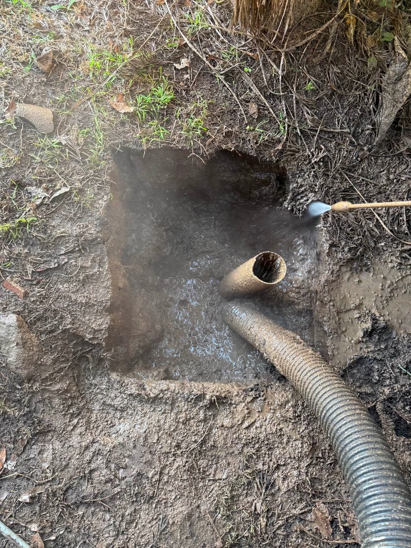 Vacuum hose positioned near an exposed underground service