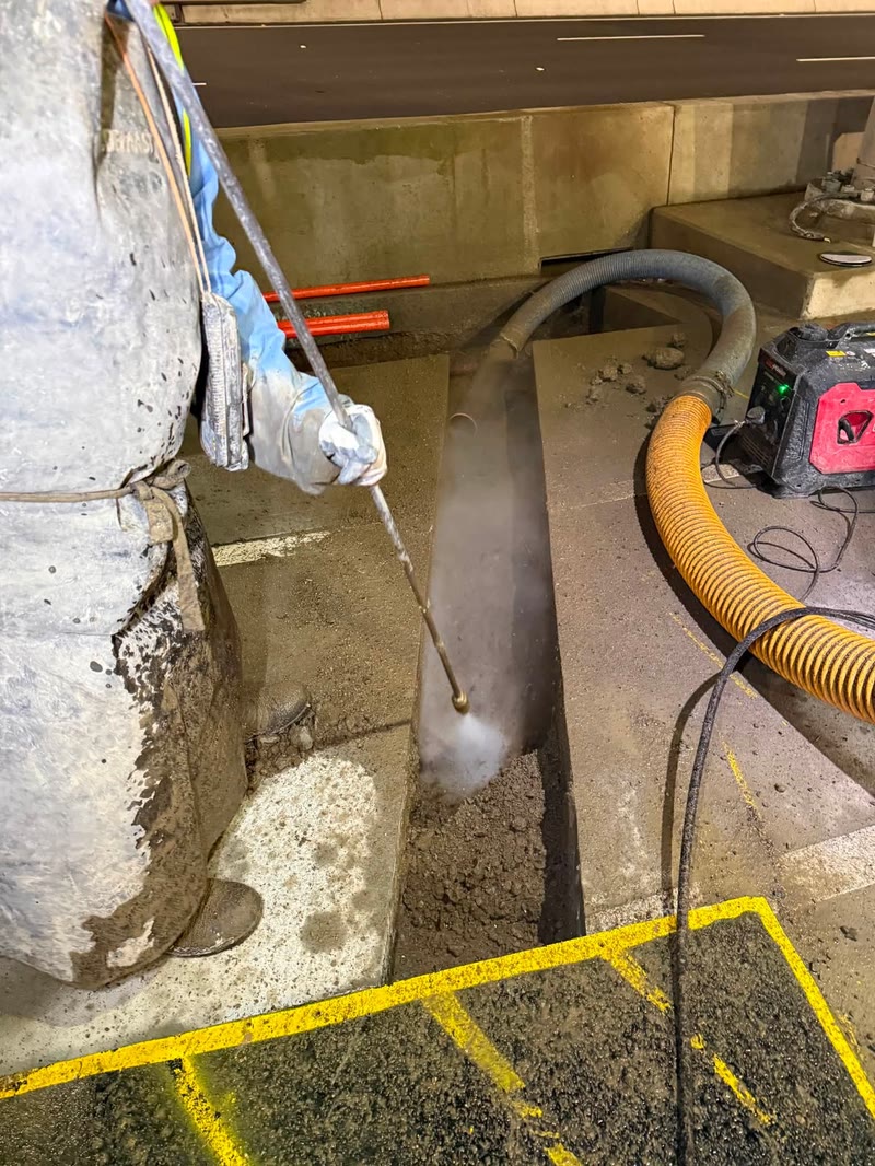 Vacuum hose operating inside a restricted-access concrete area