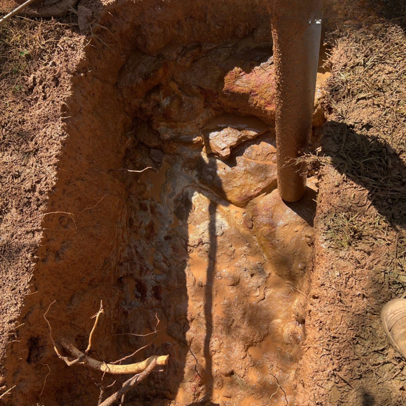 Vacuum hose working around exposed services in a trench