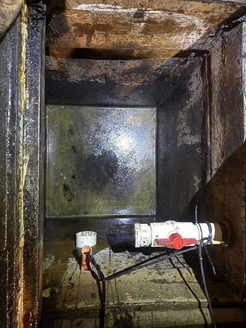 Water-filled concrete service pit during cleaning