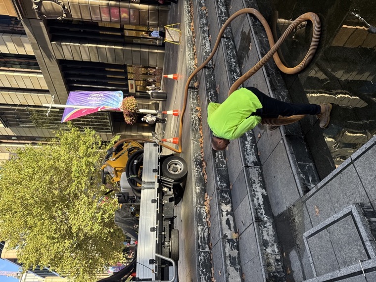 Small vac truck operator cleaning stormwater drains Sydney CBD