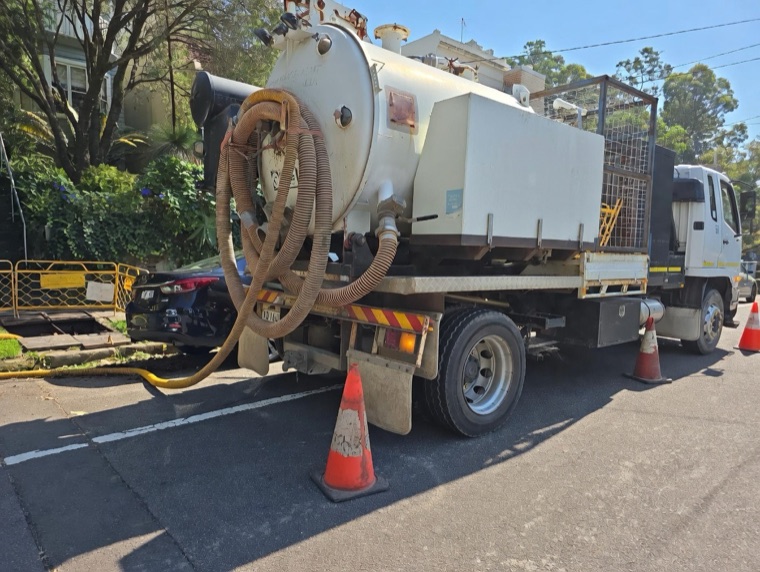 Vac truck on site residential street Sydney with safety cones