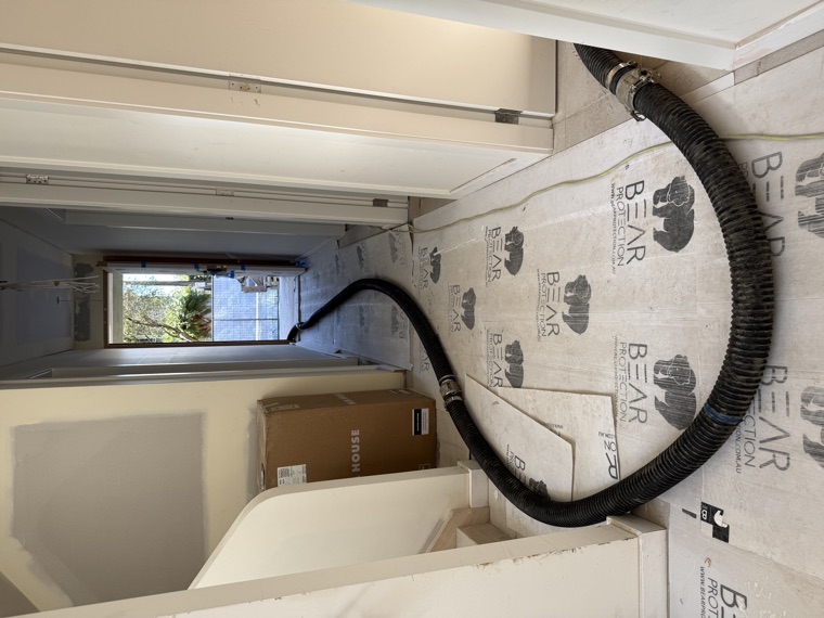 Vac hose through building interior tight access Sydney
