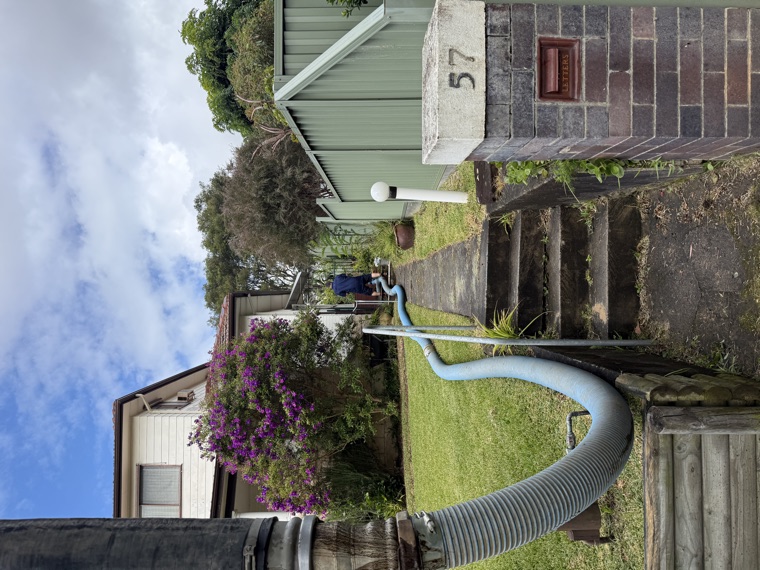 Vac truck hose through residential front yard to driveway Sydney
