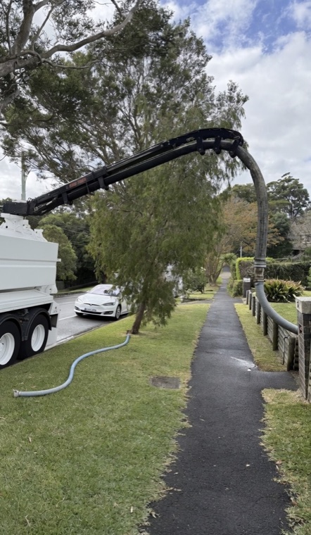 Vac truck boom arm extended over trees residential tight access Sydney