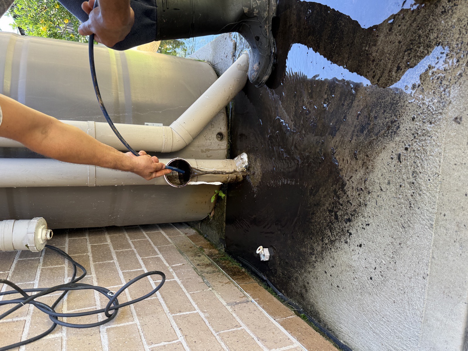 Blocked stormwater downpipe on Sydney property before unblocking by hydro vac crew