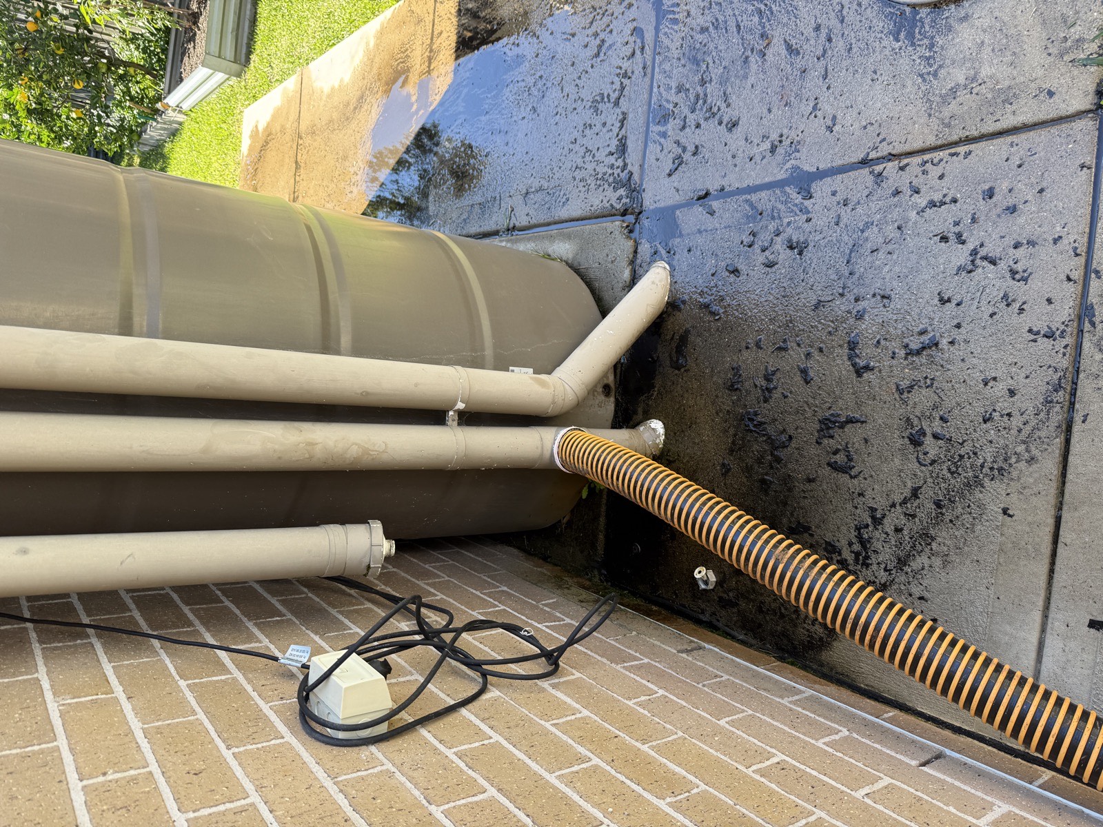 Hydro vacuum hose connected to blocked downpipe for stormwater drain clearing Sydney