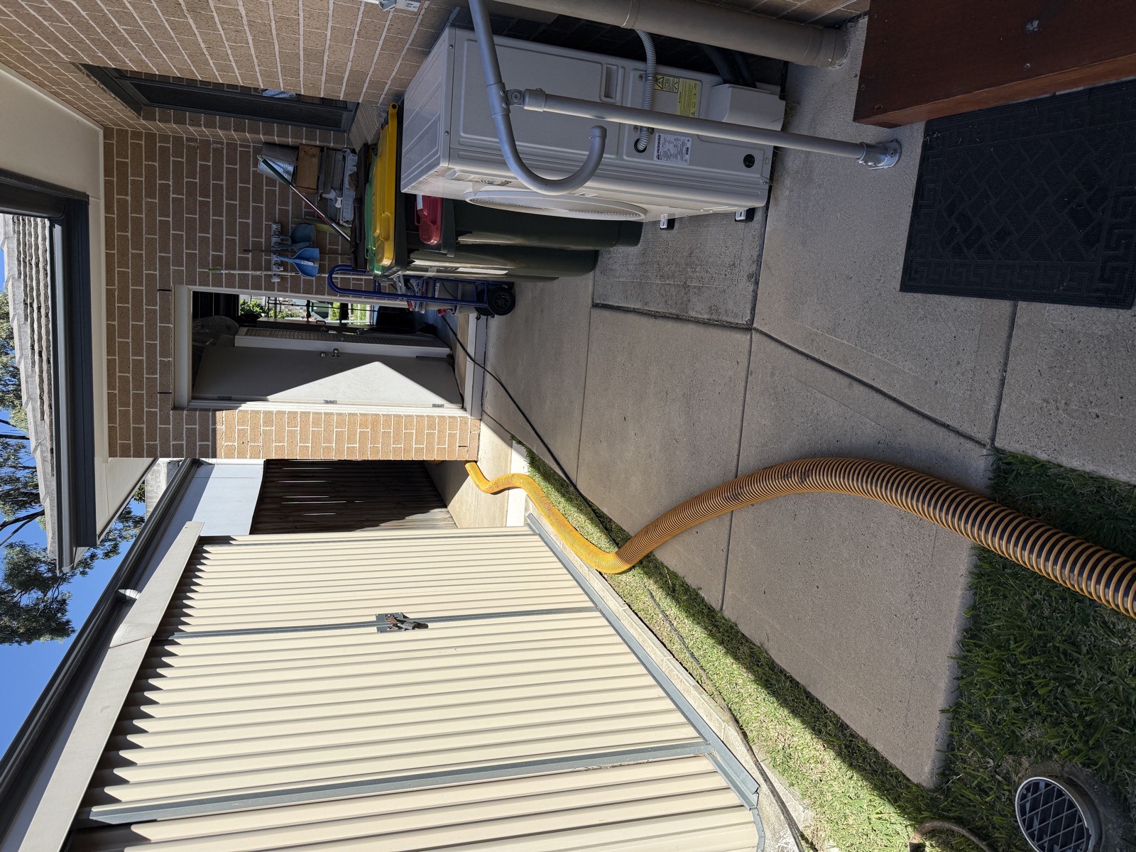 Vac truck suction hose clearing blocked downpipe at Sydney property side access